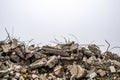 The rebar sticking up from piles of brick rubble, stone and concrete rubble against the sky in a haze Royalty Free Stock Photo