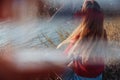 Rebel careless ginger girl in red sweater smoking near sea in sunrise Royalty Free Stock Photo