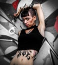 Rebel tattooed girl shows handcuffs Royalty Free Stock Photo