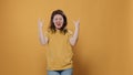 Rebel woman with positive attitude doing rock and roll hand gesture with tongue out wanting to party Royalty Free Stock Photo