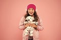 Rebellious spirit. cosy winter season. pet care. warm clothes for cold weather. happy little girl play dog toy. pink is Royalty Free Stock Photo