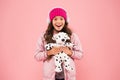 Rebellious spirit. cosy winter season. pet care. warm clothes for cold weather. happy little girl play dog toy. pink is Royalty Free Stock Photo