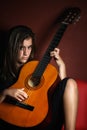 Rebellious teenage girl holding an acoustic guitar Royalty Free Stock Photo