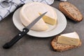 French Reblochon cheese on a plate with a knife