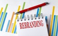 REBRANDING text on a notebook with chart and pen business concept Royalty Free Stock Photo