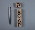 Recap word text on wooden cube blocks. Summary concept