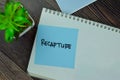 Recapture write on sticky notes isolated on Wooden Table Royalty Free Stock Photo