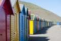 Receding line of colorful wooden beach huts