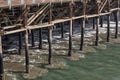 Receding waves under and around wood pilings of an ocean pier, Santa Monica CA