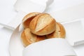 Pile of german wheat buns  wrapped into thermal paper for receipts on white uniform background, showing german blank receipts to Royalty Free Stock Photo