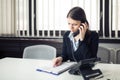 Receiving bad news phone call.Looking confused checking notes and paperwork.Manager solving mistake Royalty Free Stock Photo