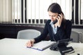 Receiving bad news phone call.Looking confused checking notes and paperwork.Manager solving mistake Royalty Free Stock Photo