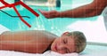 Receiving client lying on massage table at pool, with therapist in uniform and graphic overlays Royalty Free Stock Photo