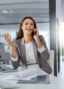 Receiving some positive feedback from a satisfied client. a young businesswoman talking on a cellphone in an office. Royalty Free Stock Photo