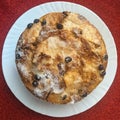 Homemade apple, raisin and cranberry pie, with red textile background