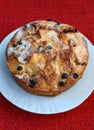 Homemade apple, raisin and cranberry pie, on a white plate