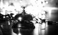 Reception bell on the table and shining garland background