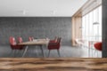 Reception desk. Grey office room blurred, wooden tables and red chairs on marble floor