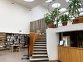 Reception and stairs in the library, shelves with books. Minimalistic interior. The library by Alvar Aalto