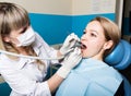 The reception was at the female dentist. Doctor examines the oral cavity on tooth decay. Caries protection. doctor puts Royalty Free Stock Photo