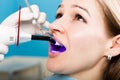 The reception was at the female dentist. Doctor examines the oral cavity on tooth decay. Caries protection. doctor puts Royalty Free Stock Photo