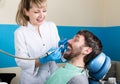 The reception was at the female dentist. Doctor examines the oral cavity on tooth decay. Caries protection. doctor puts Royalty Free Stock Photo