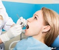 The reception was at the female dentist. Doctor examines the oral cavity on tooth decay. Caries protection. Tooth decay Royalty Free Stock Photo