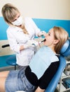 The reception was at the female dentist. Doctor examines the oral cavity on tooth decay. Caries protection. Tooth decay Royalty Free Stock Photo