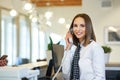 Receptionist answering phone at hotel front desk