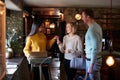 Receptionist Handing Guest Couple Key As They Check Into Hotel Royalty Free Stock Photo