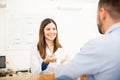 Receptionist handing results to patient Royalty Free Stock Photo