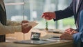 Receptionist hands giving keys at hotel counter closeup. Tourist couple check in Royalty Free Stock Photo