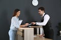 Receptionist registering client at desk