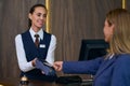 Receptionist registrating guest in the hotel Royalty Free Stock Photo