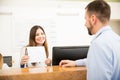 Receptionist showing services and costs Royalty Free Stock Photo