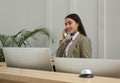 Beautiful receptionist talking on phone at counter in hotel Royalty Free Stock Photo