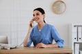 Receptionist talking on phone at countertop Royalty Free Stock Photo