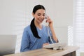 Receptionist talking on phone at countertop Royalty Free Stock Photo