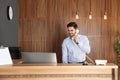 Receptionist talking on phone at desk Royalty Free Stock Photo