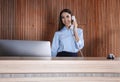 Receptionist talking on phone at desk Royalty Free Stock Photo