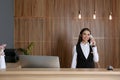 Receptionist talking on phone at desk Royalty Free Stock Photo