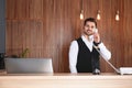 Receptionist talking on phone at desk Royalty Free Stock Photo