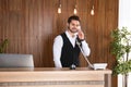 Receptionist talking on phone at desk Royalty Free Stock Photo