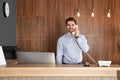 Receptionist talking on phone at desk Royalty Free Stock Photo