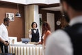 Receptionist talking to hotel guests Royalty Free Stock Photo