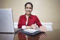 Receptionist Writing In Diary In Office Royalty Free Stock Photo