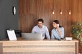 Receptionists working at desk in lobby Royalty Free Stock Photo