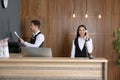 Receptionists working at desk in lobby