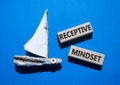 Receptive Mindset symbol. Concept word Receptive Mindset on wooden blocks. Beautiful blue background with boat. Business and