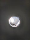 Recessed ceiling light fixture with reflective surface and visible debris. Royalty Free Stock Photo